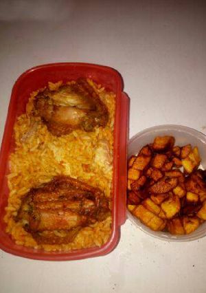A picture of Jollof rice with chicken and fried plantain.