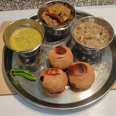 A picture of Litti chokha with mutton stew.