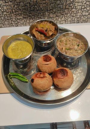 A picture of Litti chokha with mutton stew.