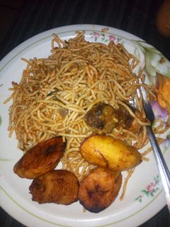 A picture of Jollof spaghetti with fried plantain.