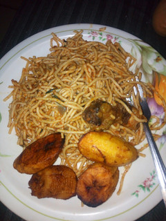 A picture of Jollof spaghetti with fried plantain.