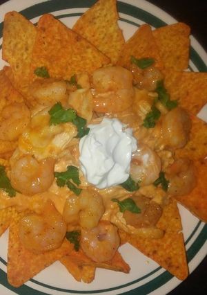 A picture of Buffalo chicken and shrimp nachos.