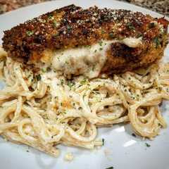 A picture of Mozzarella Stuffed Chicken with Spaghetti in Cream Sauce.