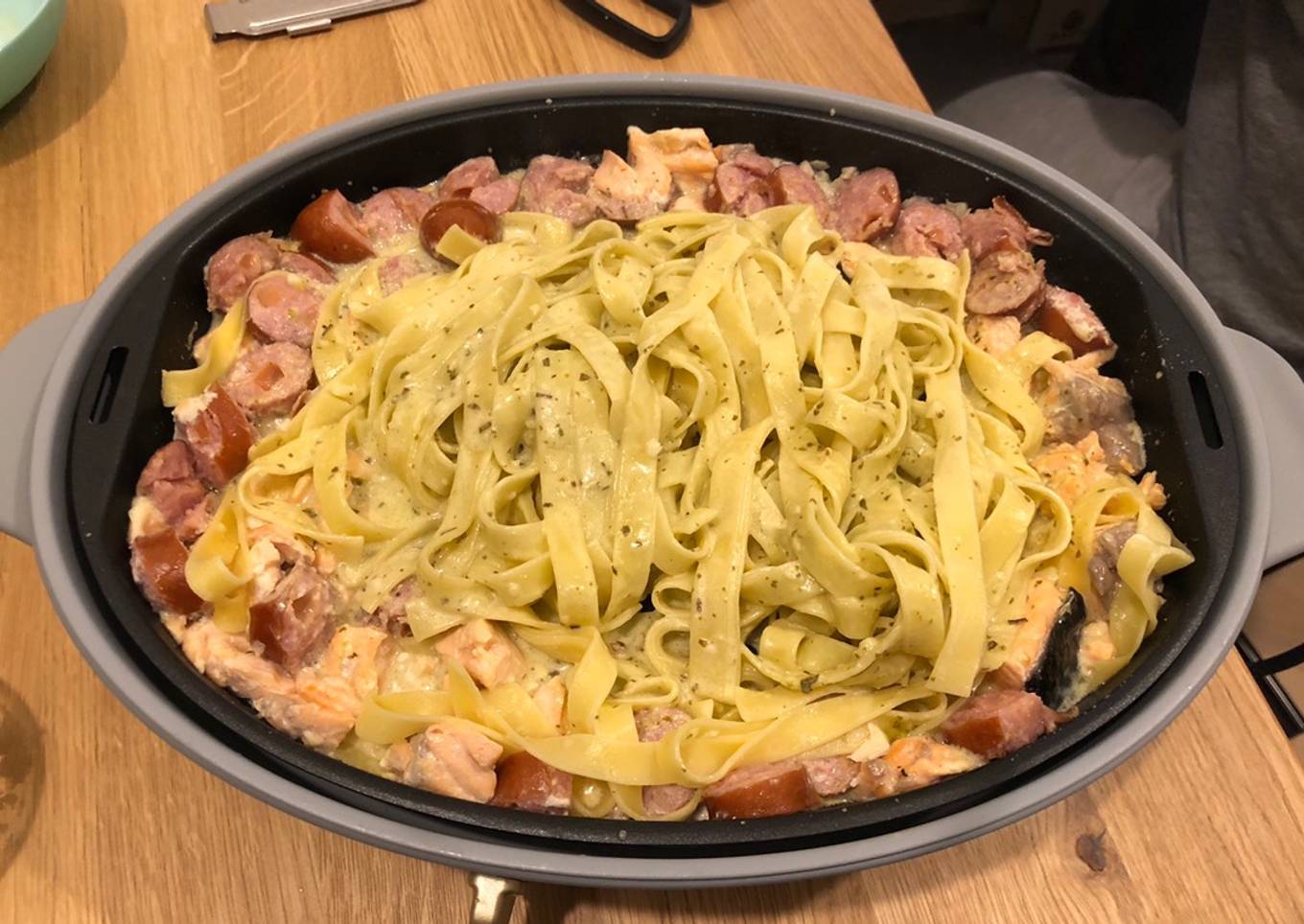 Fettucine with pesto, salmon and sausage