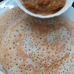 A picture of Dosa With Chicken Curry.