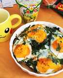 Baked eggs on seasonal greens and prosciutto