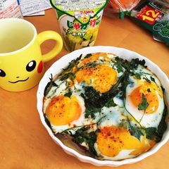 A picture of Baked eggs on seasonal greens and prosciutto.