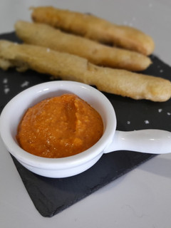 Una foto de Calcots asados en tempura con salsa romesco