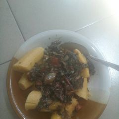 A picture of Unripe plantain with vegetable sauce.