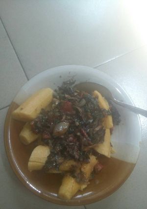 A picture of Unripe plantain with vegetable sauce.