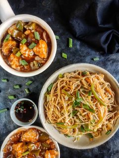 A picture of Veg noodles with chicken Manchurian.