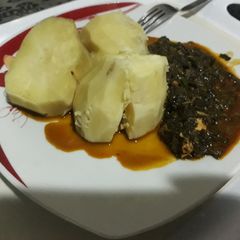 A picture of Boiled potatoes with vegetable sauce.