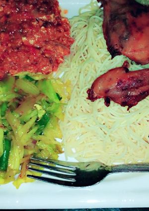 A picture of White spaghetti, egg stew,steamed cabbage and fried chicken.