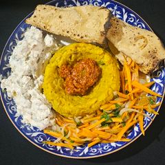 A picture of Satvik khichdi Buddha bowl(raita,saute vegetables, papad.).