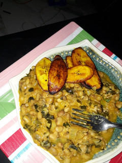 A picture of Porriage beans with fried plantain and scent leaf.