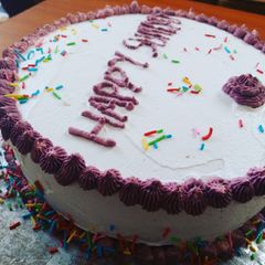 A picture of Strawberry cake with whipping cream decoration.