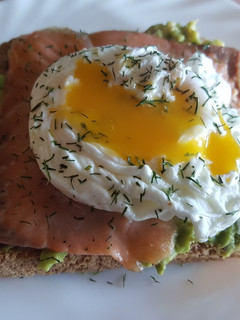Una foto de Tostas de aguacate y salmón ahumado con huevos escalfados