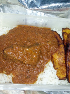 A picture of White rice and stew and fried plantain.