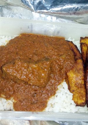 A picture of White rice and stew and fried plantain.