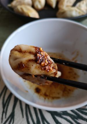 A picture of White bean dumplings dip in sichuan dipsauce.
