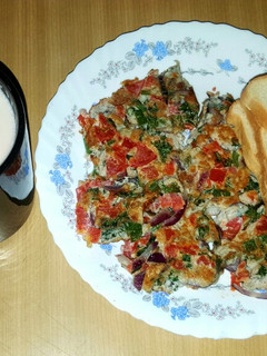 A picture of Breakfast spanish omelette with bread.