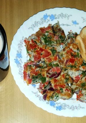 A picture of Breakfast spanish omelette with bread.