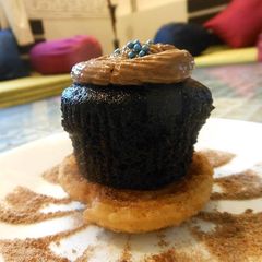 A picture of Cinnamon Disk topped with Chocolate Muffin.