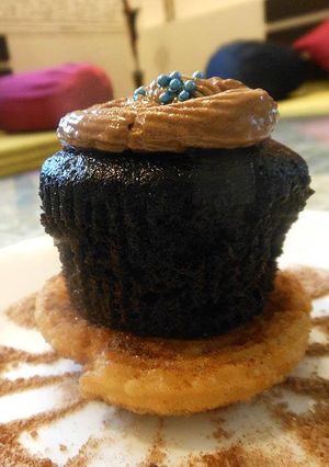 A picture of Cinnamon Disk topped with Chocolate Muffin.