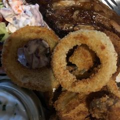 A picture of Parmesan breaded onion rings.