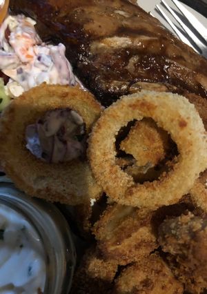 A picture of Parmesan breaded onion rings.