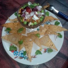 A picture of Roasted tomato with fruit salsa.