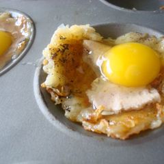 A picture of Baked eggs in shredded potato cheese cups.