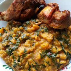 A picture of Unripe plantain porriage with fried chicken.