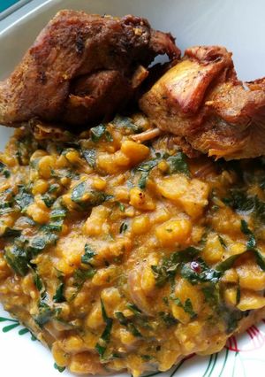 A picture of Unripe plantain porriage with fried chicken.