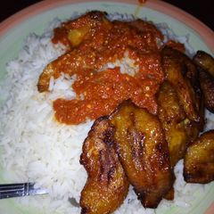 A picture of Rice,stew and plantain.