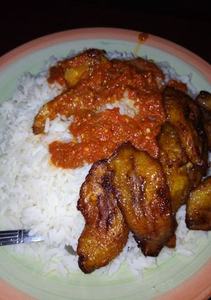 A picture of Rice,stew and plantain.