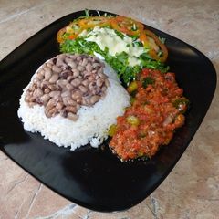 A picture of Rice and beans with stew.
