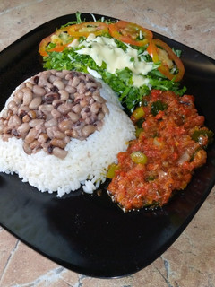 A picture of Rice and beans with stew.