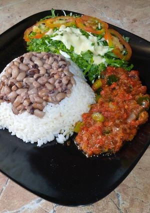A picture of Rice and beans with stew.