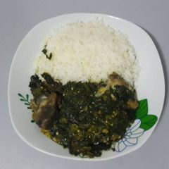 A picture of White rice with vegetable sauce.