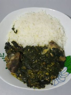 A picture of White rice with vegetable sauce.