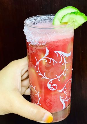 A picture of Mixed fruit cooler with chunks of cucumber.