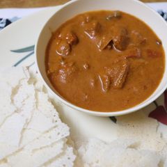 A picture of Mangalorean Chicken Gravy with Kori Roti.