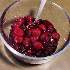 A picture of Red cherries/ mixed berries sauce/ dessert.
