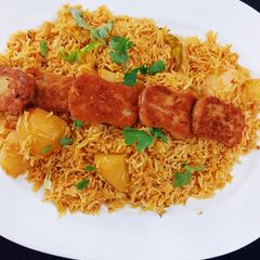 A picture of Alu ka pulao with nuggets.