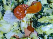 A picture of scrambled eggs with tomatoes