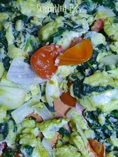 A picture of Scrambled Eggs with Spinach and Cherry Tomatoes.