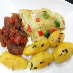 Buttered Irish potatoes, pomo and fried egg A picture of Buttered Irish potatoes, pomo and fried egg.