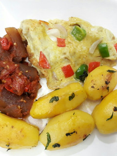 A picture of Buttered Irish potatoes, pomo and fried egg.