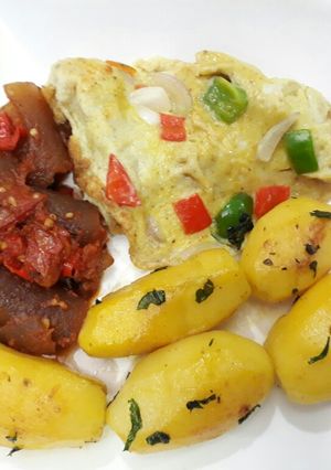 A picture of Buttered Irish potatoes, pomo and fried egg.